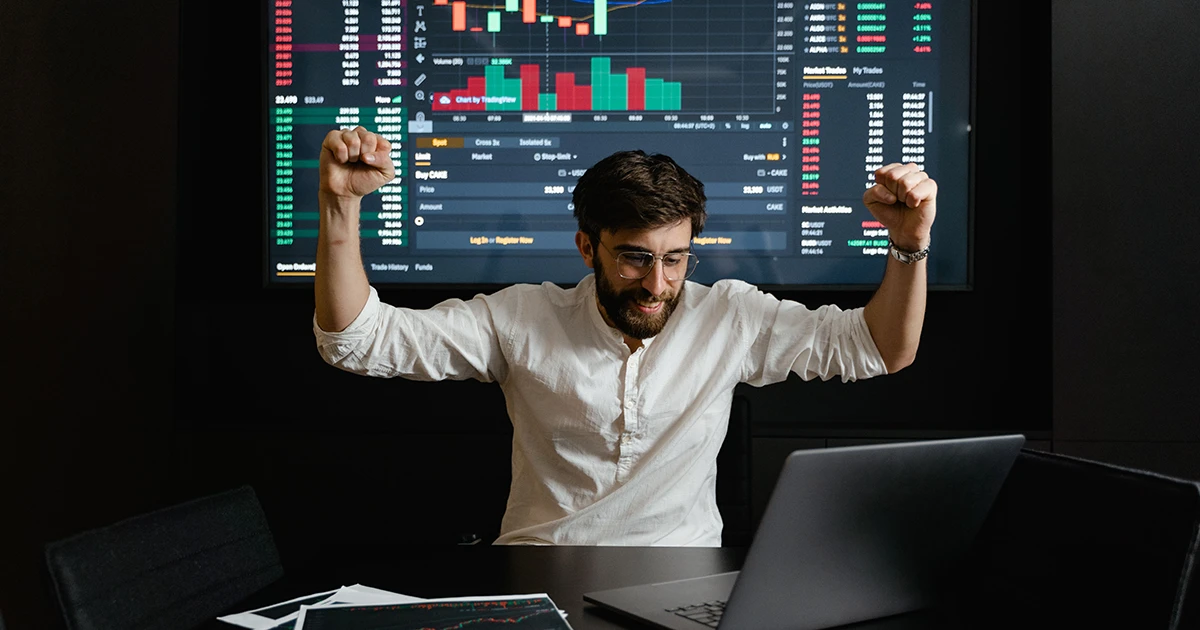 Investor reviewing portfolio charts on a computer screen during a volatile market period